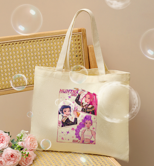 Kpop Demon Hunters canvas tote bag displayed on chair, large shoulder bag with vintage-inspired design, durable cotton canvas, stylish and functional for everyday use.