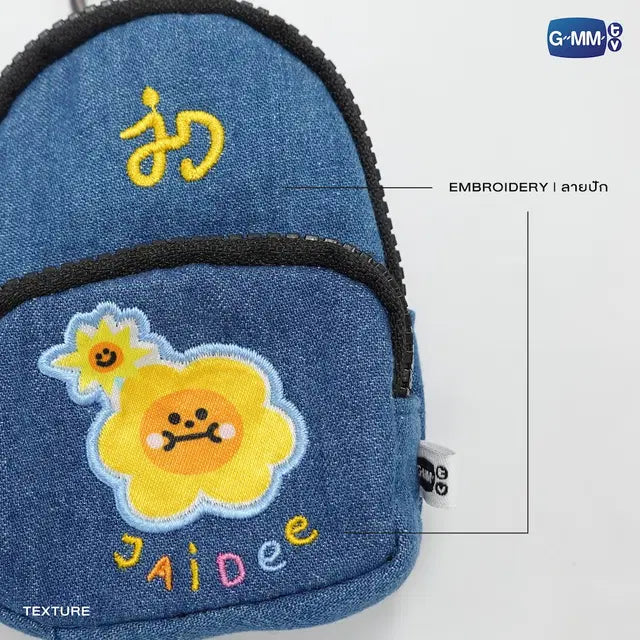 JAIDEE mini backpack charm close up official GMMTV merchandise showing denim texture embroidery and clip attachment