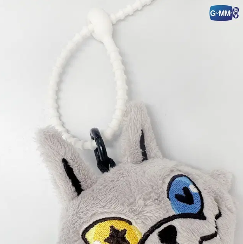 Close-up of the LYKYOU GMMTV plush keychain front, showing the wolf’s heterochromatic eyes, EF plush fabric texture, and fine stitching.